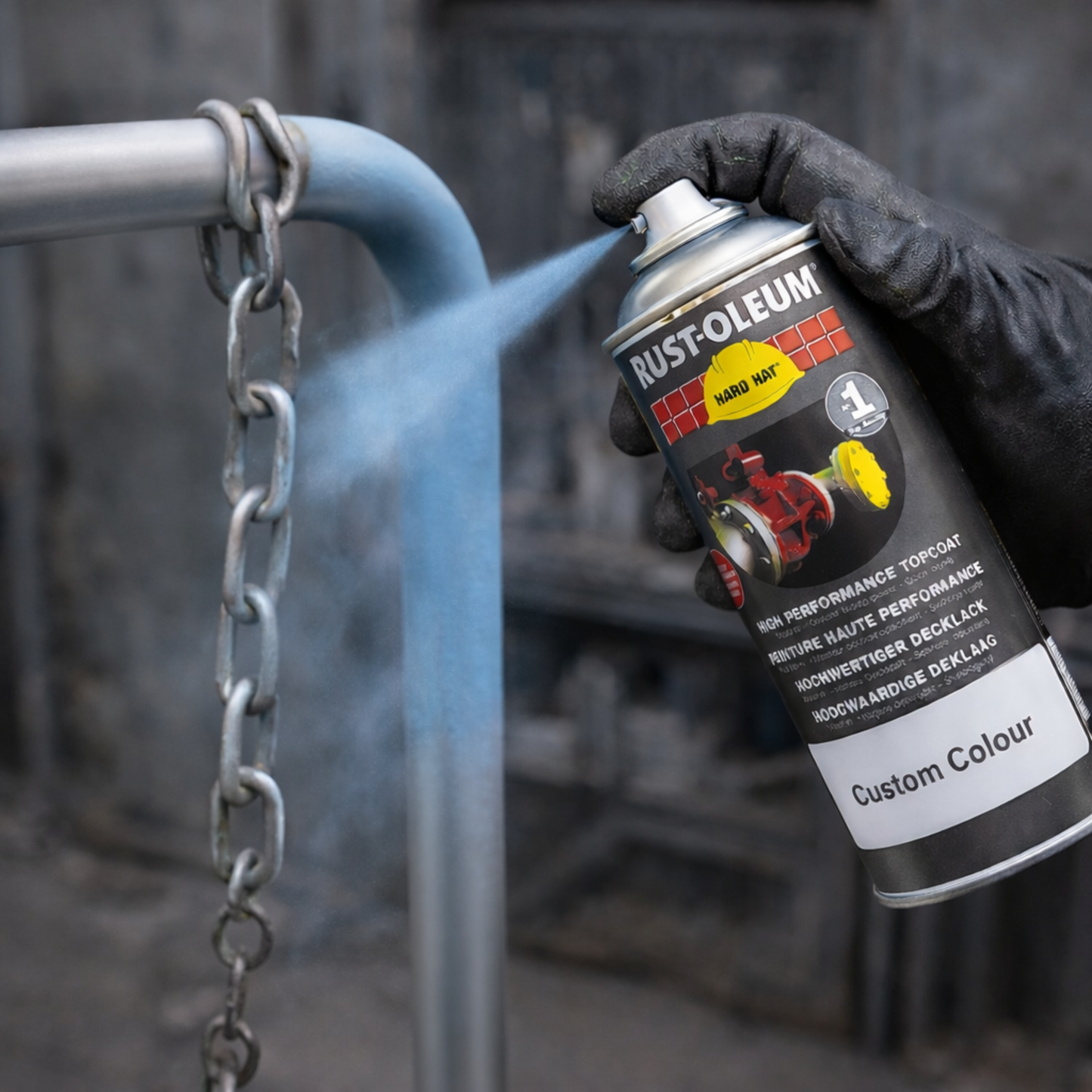 Hand holding a Rust-Oleum spray can spraying a metal surface.