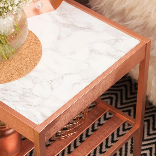 Wooden side table with marble-like top and shelf, on a patterned rug.