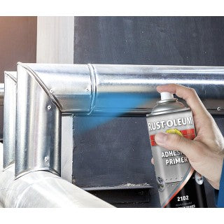 Rust-Oleum aerosol primer being applied to a picture frame